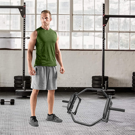 Pura Neve ForzaHex in a gym setting with a man ready for deadlifts or shrugs, showcasing stability and strength.